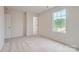 Well-lit bedroom features a large window overlooking the neighborhood and plush carpeting at 155 Astor St, Troutman, NC 28166