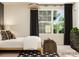 Airy bedroom with large windows, decorative lighting, dark curtains and woven baskets at the foot of the bed at 155 Astor St, Troutman, NC 28166