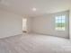 Bright and airy bedroom with neutral carpet, large window, and ample natural light at 155 Astor St, Troutman, NC 28166