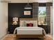 Stylish bedroom with a dark accent wall, dinosaur-themed decor, decorative pillows, and patterned curtains at 155 Astor St, Troutman, NC 28166