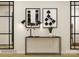 A foyer decorated with geometric artwork, lamps, and a decorative hall table and a large mirror at 155 Astor St, Troutman, NC 28166