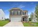 Charming two-story home with a two-car garage, well-maintained lawn, and inviting front entrance at 155 Astor St, Troutman, NC 28166