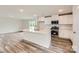 Modern kitchen with white cabinets, stainless steel appliances, and a center island with sink at 155 Astor St, Troutman, NC 28166