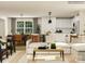 Bright, modern living room with large sectional, wood floors, and view into the dining area at 155 Astor St, Troutman, NC 28166