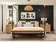 Elegant main bedroom featuring a four-poster bed, stylish decor, and ample natural light at 155 Astor St, Troutman, NC 28166