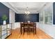 Elegant dining room with hardwood floors, coffered ceiling, and wainscoting perfect for gatherings at 15807 Foreleigh Rd, Huntersville, NC 28078