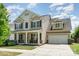 Inviting two-story home with a charming front porch, well-manicured lawn, and a two-car garage at 15807 Foreleigh Rd, Huntersville, NC 28078
