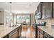 Modern kitchen featuring granite countertops, stainless steel appliances, and a view to the breakfast area at 15807 Foreleigh Rd, Huntersville, NC 28078