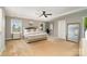 Spacious main bedroom with a tray ceiling, large windows, and elegant furniture at 15807 Foreleigh Rd, Huntersville, NC 28078