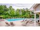 Community pool surrounded by lounge chairs and lush greenery for relaxation and outdoor enjoyment at 15807 Foreleigh Rd, Huntersville, NC 28078