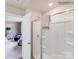 Bright bathroom showing glass enclosed shower and door to bedroom with chair and nightstand at 1611 Spring Lot Dr, Edgemoor, SC 29712