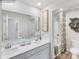 Bathroom with double sinks, white cabinets, and shower/tub with patterned curtain at 1611 Spring Lot Dr, Edgemoor, SC 29712
