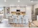 Bright kitchen features an island with bar seating, stainless steel appliances, and white cabinets at 1611 Spring Lot Dr, Edgemoor, SC 29712