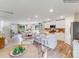 Open-concept kitchen with a large island, bar seating, and a view into the dining and living areas at 1611 Spring Lot Dr, Edgemoor, SC 29712