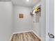 Functional laundry room with shelving for storage and wood-look flooring at 1611 Spring Lot Dr, Edgemoor, SC 29712