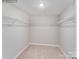 Bright walk-in closet with carpet, white walls, and metal shelving for storage at 1611 Spring Lot Dr, Edgemoor, SC 29712