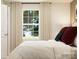 Bright bedroom featuring a large window with natural light and neutral-toned curtains at 1621 Spring Lot Dr, Edgemoor, SC 29712