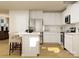 Bright open kitchen featuring a center island with seating, stainless steel appliances, and sleek white cabinets at 1621 Spring Lot Dr, Edgemoor, SC 29712