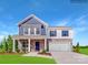 Two-story home featuring a stone and siding facade, covered front porch and two car garage at 1623 Spring Lot Dr, Edgemoor, SC 29712