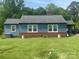 Charming single-story home with blue siding, brick foundation and a large yard at 1658 Hillcrest Ave, Lancaster, SC 29720