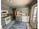 Modern kitchen features gray cabinets, marble-look countertops, and stainless steel appliances at 1658 Hillcrest Ave, Lancaster, SC 29720