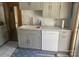 Kitchen features gray cabinets, sleek marble-look countertops, and modern stainless steel appliances at 1658 Hillcrest Ave, Lancaster, SC 29720