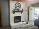 Living room featuring a white brick fireplace with wooden mantle and a view of the outdoor at 1658 Hillcrest Ave, Lancaster, SC 29720