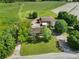 An aerial view of a home and its property featuring expansive lawns, mature trees and a large outbuilding at 1723 Baskins Hill Rd, Heath Springs, SC 29058