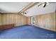 Cozy bedroom with wood paneling, ceiling fans, and a bright window at 1723 Baskins Hill Rd, Heath Springs, SC 29058