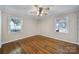 Bright bedroom with hardwood floors, overhead lighting, and two large windows at 1723 Baskins Hill Rd, Heath Springs, SC 29058