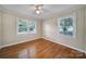 Bright bedroom featuring hardwood floors, two large windows and overhead lighting at 1723 Baskins Hill Rd, Heath Springs, SC 29058