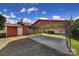 Convenient covered parking area with a metal carport and red storage building at 1723 Baskins Hill Rd, Heath Springs, SC 29058