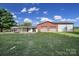 Expansive property with a house and large outbuilding, featuring multiple garage bays and well-maintained lawn at 1723 Baskins Hill Rd, Heath Springs, SC 29058