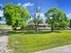 Charming brick home with a white porch surrounded by mature trees and a lush green lawn at 1723 Baskins Hill Rd, Heath Springs, SC 29058
