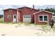 Exterior view of a detached garage with a roll-up door and ample parking space at 1723 Baskins Hill Rd, Heath Springs, SC 29058