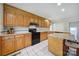 Spacious kitchen with tiled floors, wooden cabinets, and center island at 1723 Baskins Hill Rd, Heath Springs, SC 29058