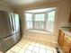Kitchen window nook features stainless refrigerator, natural light, and tiled floors at 1723 Baskins Hill Rd, Heath Springs, SC 29058
