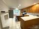 Well-lit kitchen with a charming brick fireplace and stainless steel appliances at 1723 Baskins Hill Rd, Heath Springs, SC 29058