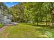 Beautiful backyard featuring a deck, shed, mature trees, and lush grass at 1760 Jacobs Way, Sherrills Ford, NC 28673