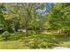 Large, lush backyard with mature trees and a storage shed at 1760 Jacobs Way, Sherrills Ford, NC 28673