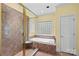 Bathroom showcasing a glass-enclosed shower, a soaking tub, and decorative tiling at 1760 Jacobs Way, Sherrills Ford, NC 28673