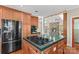Open kitchen showcasing a central cooktop island and stainless steel refrigerator at 1760 Jacobs Way, Sherrills Ford, NC 28673