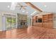 Bright living room with stone fireplace, built-in shelving, hardwood floors, and skylights at 1760 Jacobs Way, Sherrills Ford, NC 28673