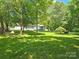 A sprawling backyard with mature trees offering shade and privacy, perfect for outdoor enjoyment at 1760 Jacobs Way, Sherrills Ford, NC 28673