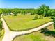 Aerial shot featuring a long driveway, fenced yard, and mature trees surrounding the property at 1780 Sierra Rd, York, SC 29745