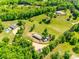 Expansive property featuring a pool, horse paddock, outbuildings, and fenced acreage, surrounded by lush trees at 1780 Sierra Rd, York, SC 29745