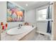 Elegant bathroom featuring a soaking tub with a decorative painting and window view at 1780 Sierra Rd, York, SC 29745