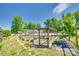 Well-maintained outdoor garden area with raised beds, a greenhouse, and a horse riding arena in the background at 1780 Sierra Rd, York, SC 29745