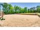 Large horse riding arena with wood fencing and a sand base, nestled among mature trees at 1780 Sierra Rd, York, SC 29745