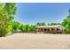 Wide shot of horse property featuring large barn and fenced pasture area on a sunny day at 1780 Sierra Rd, York, SC 29745
